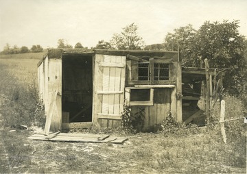 'Poultry house on the farm of Mr. W. L. Ball, R.F.D.2., Ravenwood. Mr. Ball keeps 100 hens in this house and a log poultry house of about the same size. Note the hen on the nest under the shed at the right of the house.' From photo album labeled 'Stewart A. Cody, County Agent, Jackson County, 1912.'