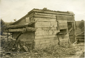 'Poultry house of Mr. W. R. Glovers, R.F.D. 2, Millwood. Twenty-seven fowls exist in this 8'x13' shed. The nest are constructed on the outside of the house, undoubtedly because of the preference of the hens.' From photo album labeled 'Stewart A. Cody, County Agent, Jackson County, 1912.'
