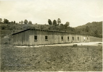 'Laying house number 2 on Mr. Stone's poultry farm. This house holding 300 hens, is ten feet wide and 100 feet long. It cost $125.' From photo album labeled 'Stewart A. Cody, County Agent, Jackson County, 1912.'