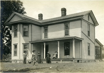 'The residence of Mr. O. M. Stone. This house was built from the proceeds of the sales of eggs on this farm. The two girls add $100 to the family purse by washing and grading the eggs.' From photo album labeled 'Stewart A. Cody, County Agent, Jackson County, 1912.'