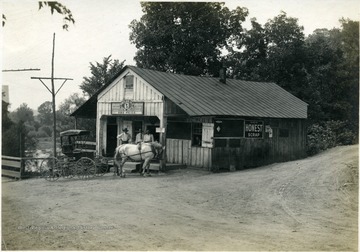 'Mr. Abe Price's Store, Cottageville. This store handles from ten to forty cases of eggs a week, in addition to several coops of chicken.' From photo album labeled 'Stewart A. Cody, County Agent, Jackson County, 1912.'