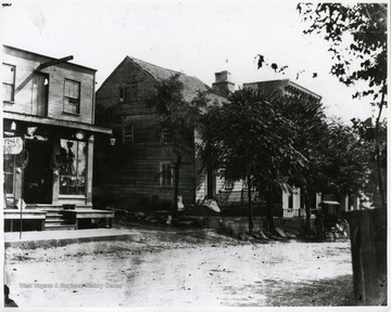 View of a street with houses and a store in Shepherdstown, W. Va. A buggy is parked in front of one of the houses.