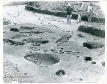 Three workers are excavating the contents of Indian Mound in the Kanawha Valley, West Virginia.