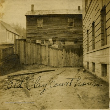 Empty lot in front of a wooden building.