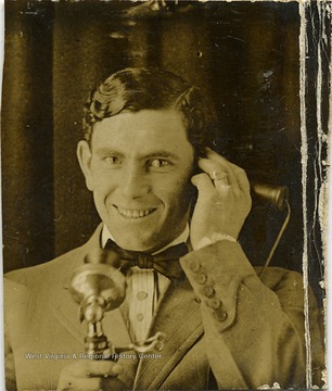 A portrait of an unidentified man on a telephone.