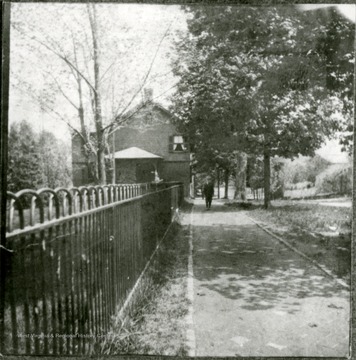 Looking east on New Street to a home now owned by Mrs. A. S. Lucas. Formerly the home of Mrs. John S. Powell and her two daughters.