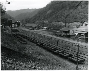 Coal Tipple, coal cars and buildings along the tracks.