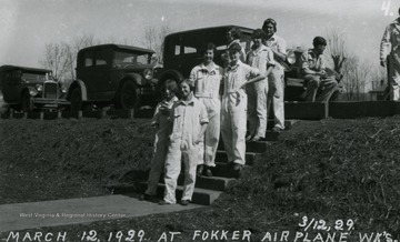 Group portrait of the women workers from Fokker Plant posing on the steps outside.
