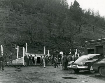 Groups of men stand outside mine #6 after an explosion.