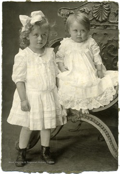 Portrait of Maggie and Helen Ballard in white dresses.