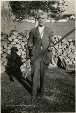 A photograph of Isaac Newton Ballard holding a gun.