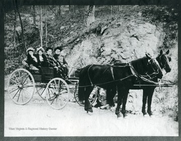 Colonel and Mrs. Bill Eubank, and Mr. and Mrs. Ben Gay are sitting in a buggy in McDowell County, West Virginia.