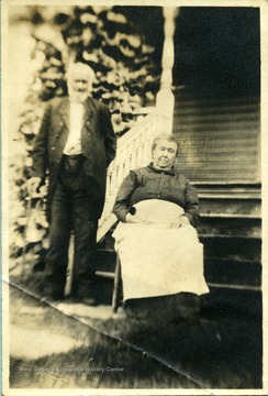 Portrait of Baldwin Ballard and wife in front of a house.