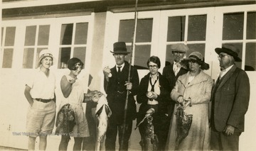 A group photo of Isaac Ballard and his family, and the fish they caught in Florida. Left to Right: 'Jorine, Catherine, Dad, George, Mac, Mrs. Brown, Davy.'
