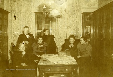 Taken in the living room of Mr. and Mrs. David Street, Park and Madison St. Baltimore, Md.  probably in the late 1890's. From left to right: Isabella T. McCullough, Mr. Charles Hatter, Jane McCullough Spence, Mrs. Hatter, Mrs. Lusselfaugh, and Sadie Street.'