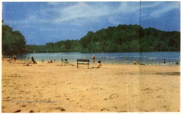 'One of Morgan county's favorite centers of recreation is the Cacapon State Park Lake just off U. S.  Route 522. Above is a view of the beach and the picturesque man made lake.'