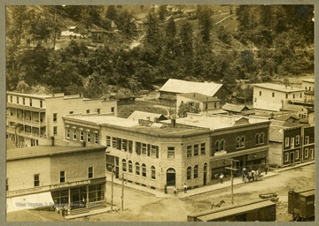A rooftop view of a bank, pharmacy and various other buildings of the town.