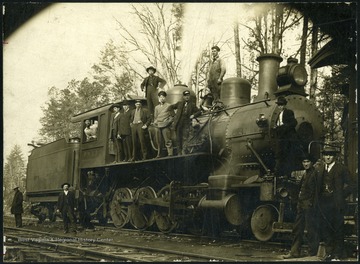 'Standing on the ground at cab entrance is Capt. T. B. Dillingham, well known conductor on the Piney River and Paint Creek Railway running between Cranberry, Skelton, Sprague, Beckley, and Beckley Junction.'