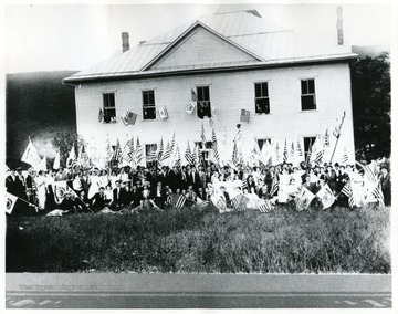 Group portrait of students and flags at Franklin's First High School, opened in 1912.