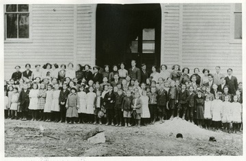 'First Class in New Schoolhouse on the Hill, 1912-1913.  Professor Jesse H. Cook, Principal; Miss Susie Daugherty and Berlin Eye, teachers.'