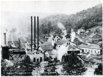 Mill buildings and stacks of lumber.