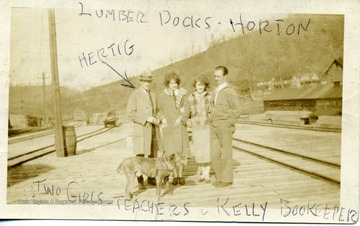 'Man on left is Ernest A. Hertig.  Two ladies in the middle were school teachers.  Man on the right is Harry Kelly, a bookkeepper.  Men are from Ellamore, W. Va.'
