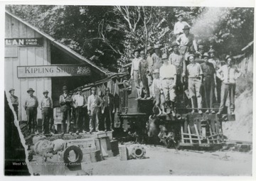 Railroad workers are posing in front of a train at the C and K Railroad at MacFarlan Station in Ritchie County, West Virginia.