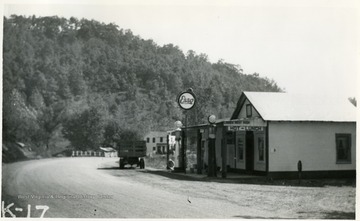 'Genoa, W. Va.  Along US Route 52, this picture shows truck making store deliveries. This truck has Boyd County, Ky. license tags.'