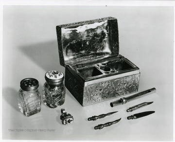 Pictured is a gold writing box as well as other objects associated with Harmon Blennerhassett.