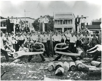 Men cutting logs for a contest in Webster County.