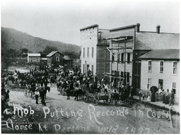 Court records and other valuables were forcibly removed from the courthouse at St. George on the night of August 1, 1893.  They were taken to Parsons and placed in a temporary courthouse.  This photo, taken in Parsons, is looking down Main Street. It is accompanied by ID #015134.