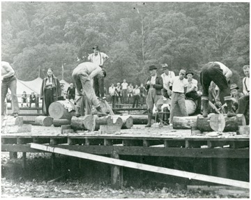 Men cutting logs for a contest in Webster County.