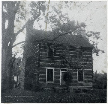 'First settlement in Summers County.  Built by Colonel James Grayham in 1770.'  The Graham House is a log cabin that was home to the first settlement. It sits next to the Greenbrier River at Lowell.