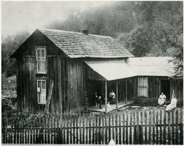 People sitting outside of the Maude Rose House in Bolair, W. Va. Picture taken sometime before 1914.