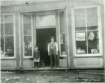 Portrait of man and young boy standing outside of the Gillespie Store in Webster Springs.