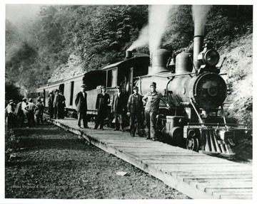 Railroad workers are loading the West Virginia Midland Railroad which is opposite of the old Webster Springs Hotel in Webster County, West Virginia. Built by the Lima Locomotive Works. 