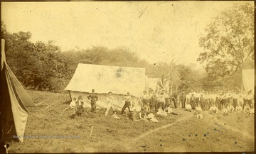 View of men by tents from the Oak Park Camping Club.