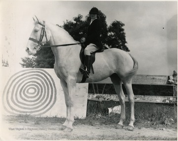 An equestrian, possibly Donna Burnham, is participating in the Buckwheat Festival in Preston County, West Virginia.