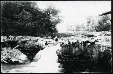 View of people sitting at the falls on Big Sandy Creek in Preston County.
