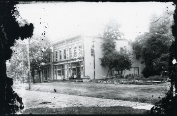 View of building on Main Street with man sitting on steps.