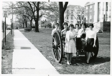 Pictured left to right; Anne Sharpe, Betty Pokrywka, Patty Sullivan, Mrs. J.E. Spafford, MaryEllen Martin and Margie Spear around a cannon.