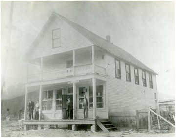 Three men and a lady on the porch of the General Store and Post Office at Lobelia.