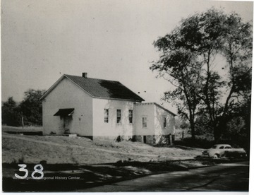 View of Rock Forge Presbyterian Church with car parked in front of building. Tha building was also used as a school.