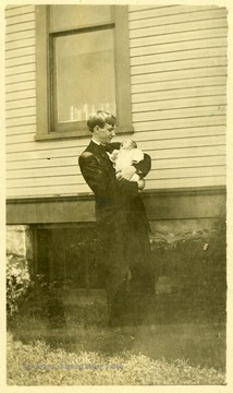 This post card says "Dear Ada May:  This is little William Robinson and his papa.  It was taken William was three weeks old.  You must stop and see him on your way home.  With love, Jeddy"  