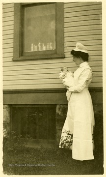 This is little William Robinson being held by a nurse.  He was just three weeks old when this photo was taken.