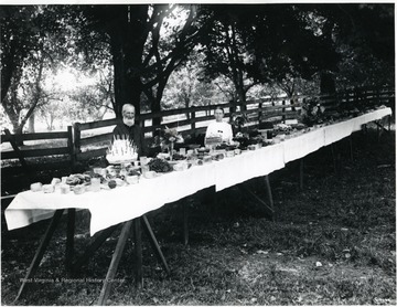 An elderly man and woman are pictured at the table.