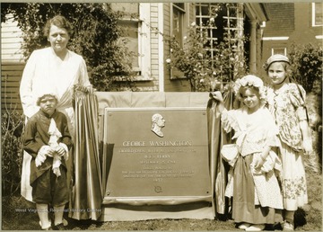 View of children standing by tablet.  Tablet reads 'George Washington crossed Cheat River at this point via Ice's Ferry September 25, 1784.  Tablet placed by the Elizabeth Ludington Hagans Chapter Daughters of the American Revolution.'