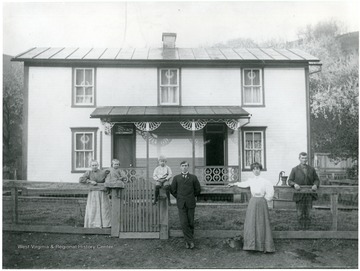 Portrait of the Shuman family standing outside of home.  Pictured- Albert, Anna Kennedy S., Edna Shuman Jones, Albert S., Wm. S., Mary Shuman Lemley, Philip Shuman (father of Albert).