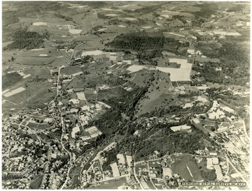Facing Northeast.  At the bottom left if Stewart Street and the brighter street is Falling Run.  It runs vertical into Stewartstown Road.  Near the top is the WVU Animal Husbandry Farm.  About three inches in from the right top is the Mileground.  The large fields to the left are part of the WVU farms.  To their left is the WVU Horticulture Farm orchards.  About and inch and a half from the bottom right is the intersections of Willey Street, Snider Street, and Monongalia Avenue at Town Hill. 
