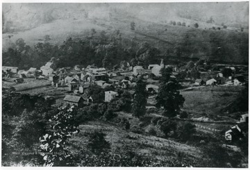 The log house is in the lower right corner; the Methodist Church is near the center of the picture and the mill is outside of the town on the left hand side.